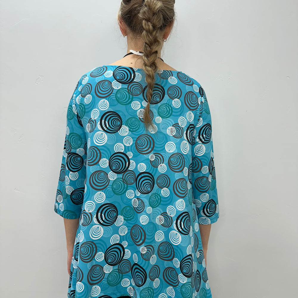 
                  
                    Teal Swirls 3/4 Sleeve Shark-bite Tunic
                  
                